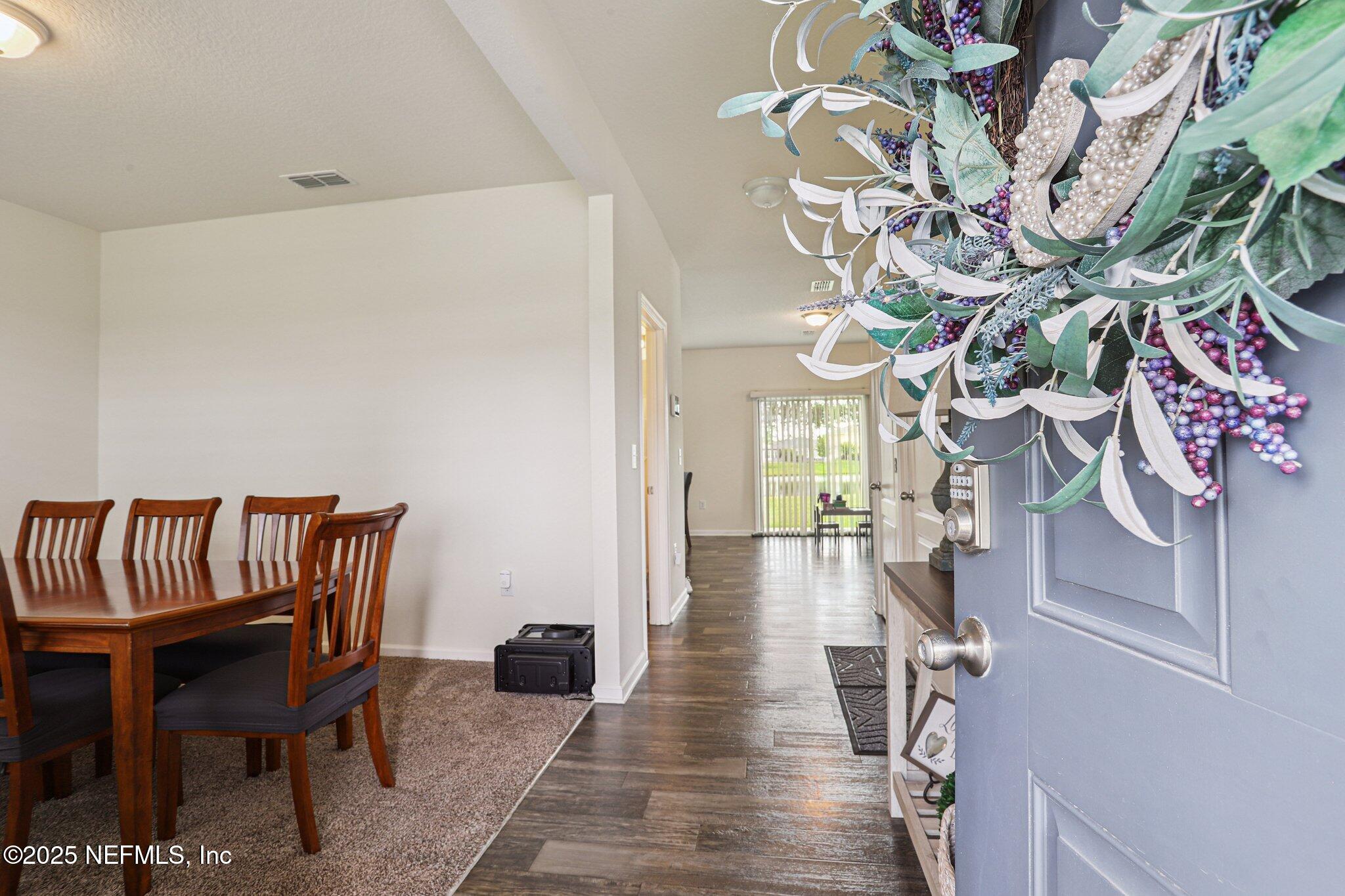 6829 Hanford Street Jacksonville, FL 32219 - Photo 3 of 24 a hallway with a dining table and chairs