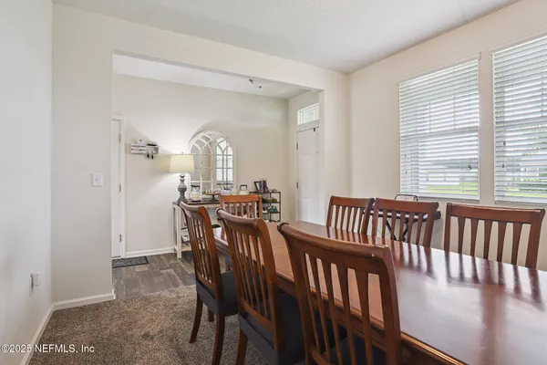a view of a dining room with furniture and window