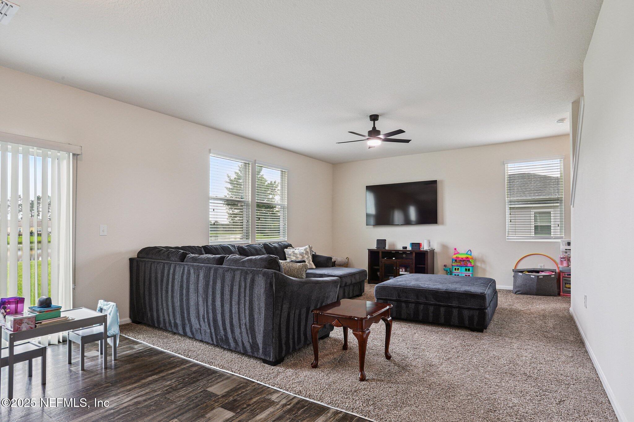 6829 Hanford Street Jacksonville, FL 32219 - Photo 7 of 24 a living room with furniture and a flat screen tv