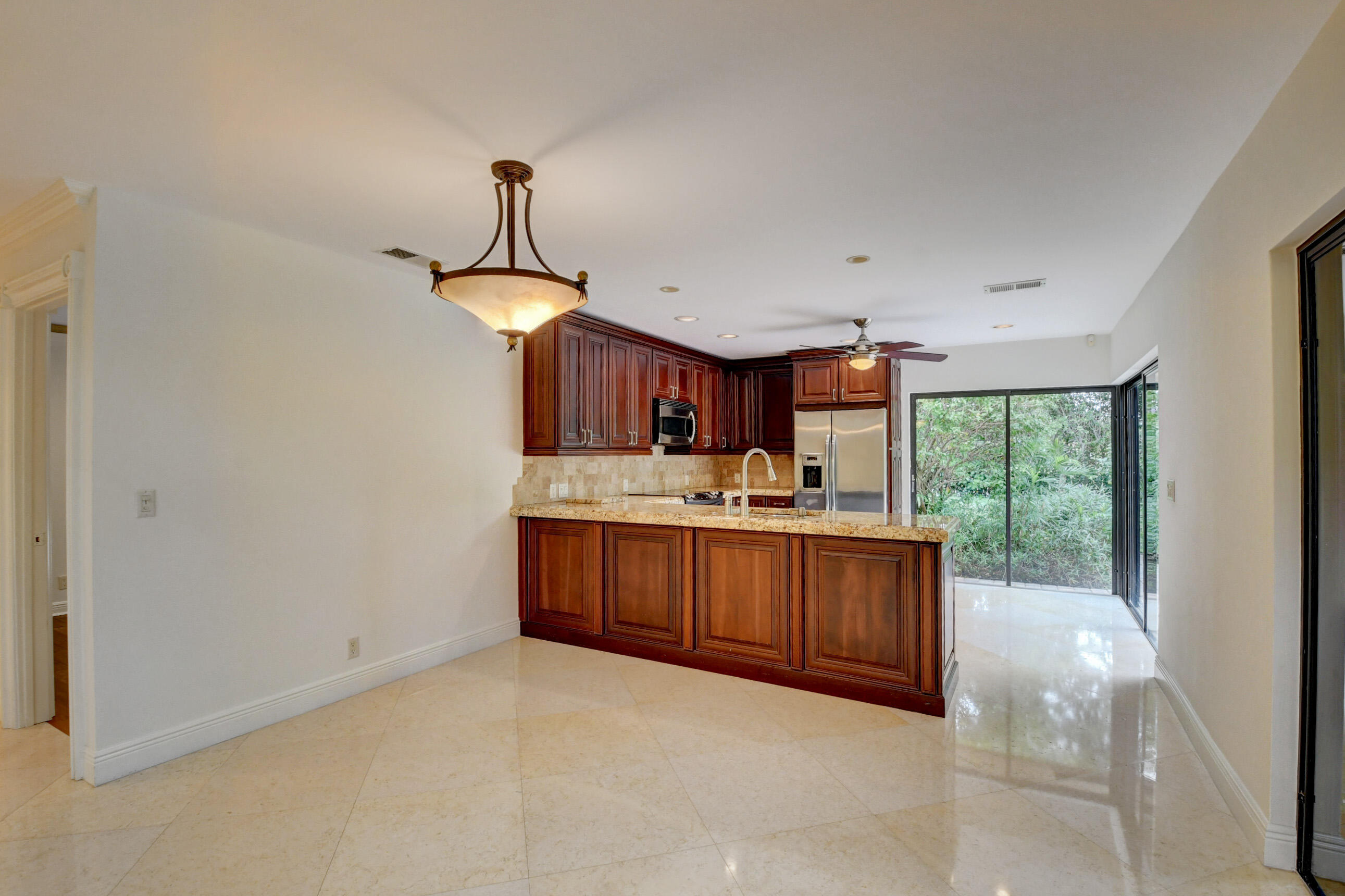 4535 Cocoplum Way Delray Beach, FL 33445 - Photo 18 of 50 Dining area adjacent to outdoor patio
