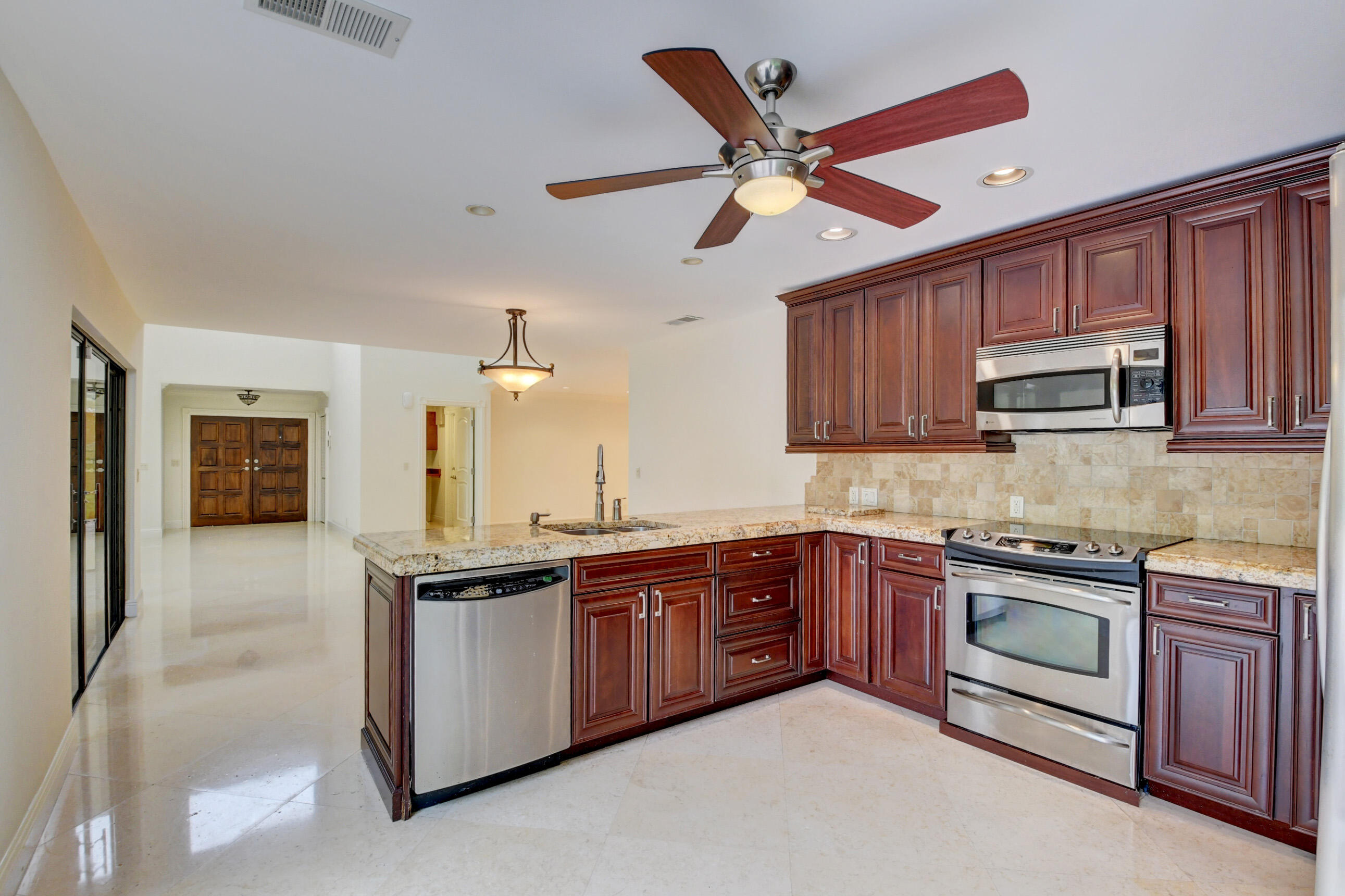 4535 Cocoplum Way Delray Beach, FL 33445 - Photo 22 of 50 Overhead ceiling fan in kitchen