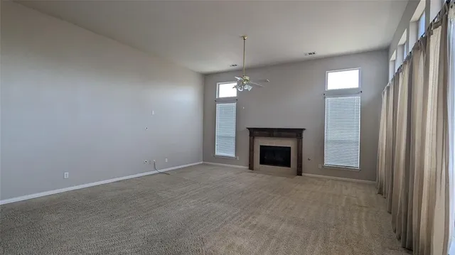 a view of a backyard with a garden and wooden fence