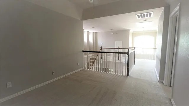 an empty room with windows and entrance