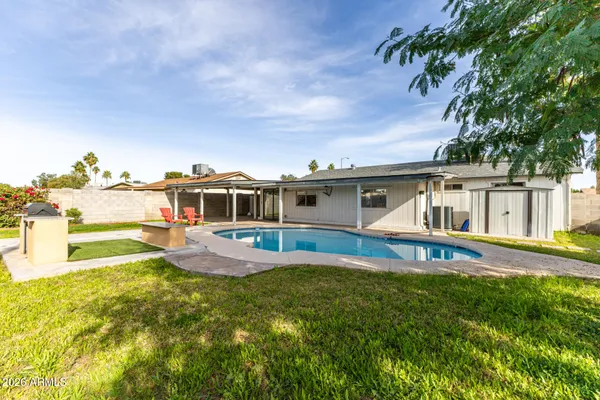 a front view of house with yard and swimming pool