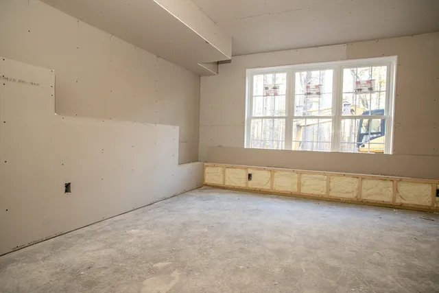 a backyard of a house with large trees and plants