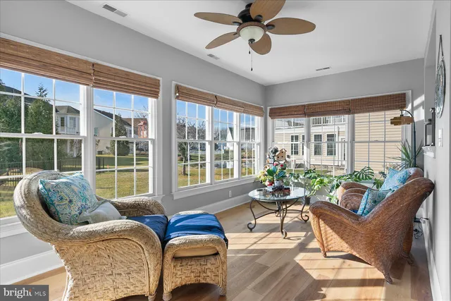 a dining room with furniture a chandelier and wooden floor