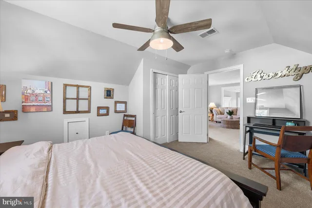 a bedroom with a large bed and a large window