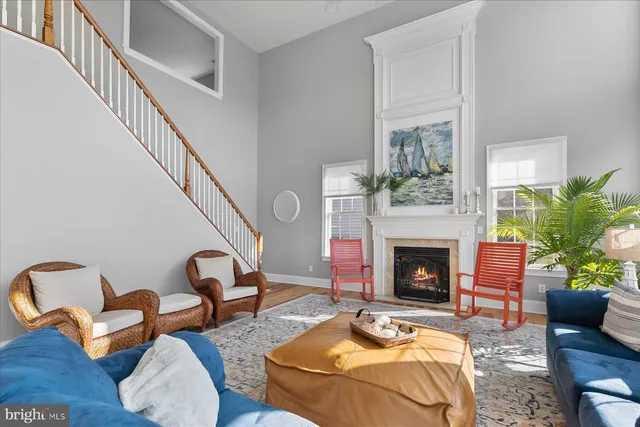 a living room filled with furniture hardwood floor and a fireplace