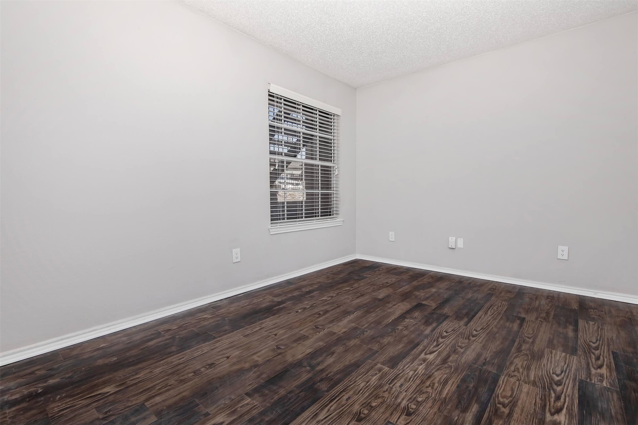 8301 Boat Club Road, Unit 715 Fort Worth, TX 76179 - Photo 10 of 44 a view of an empty room with wooden floor and a window