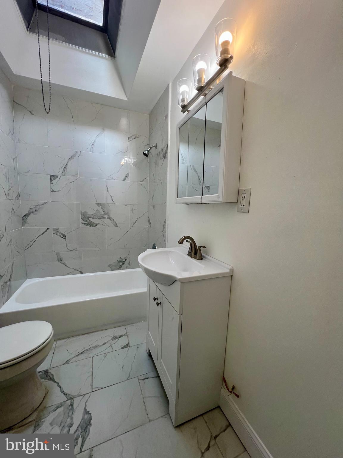 2610 Sylmar Street Philadelphia, PA 19142 - Photo 12 of 19 a bathroom with a sink a toilet and bathtub