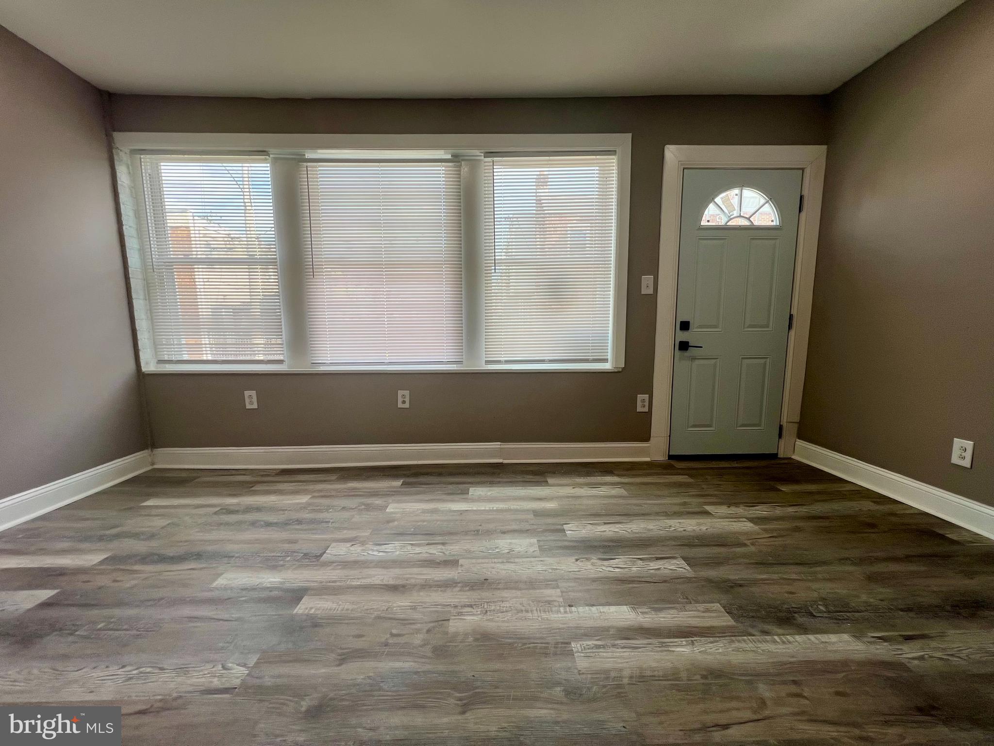 2610 Sylmar Street Philadelphia, PA 19142 - Photo 2 of 19 a view of an empty room with wooden floor and a window