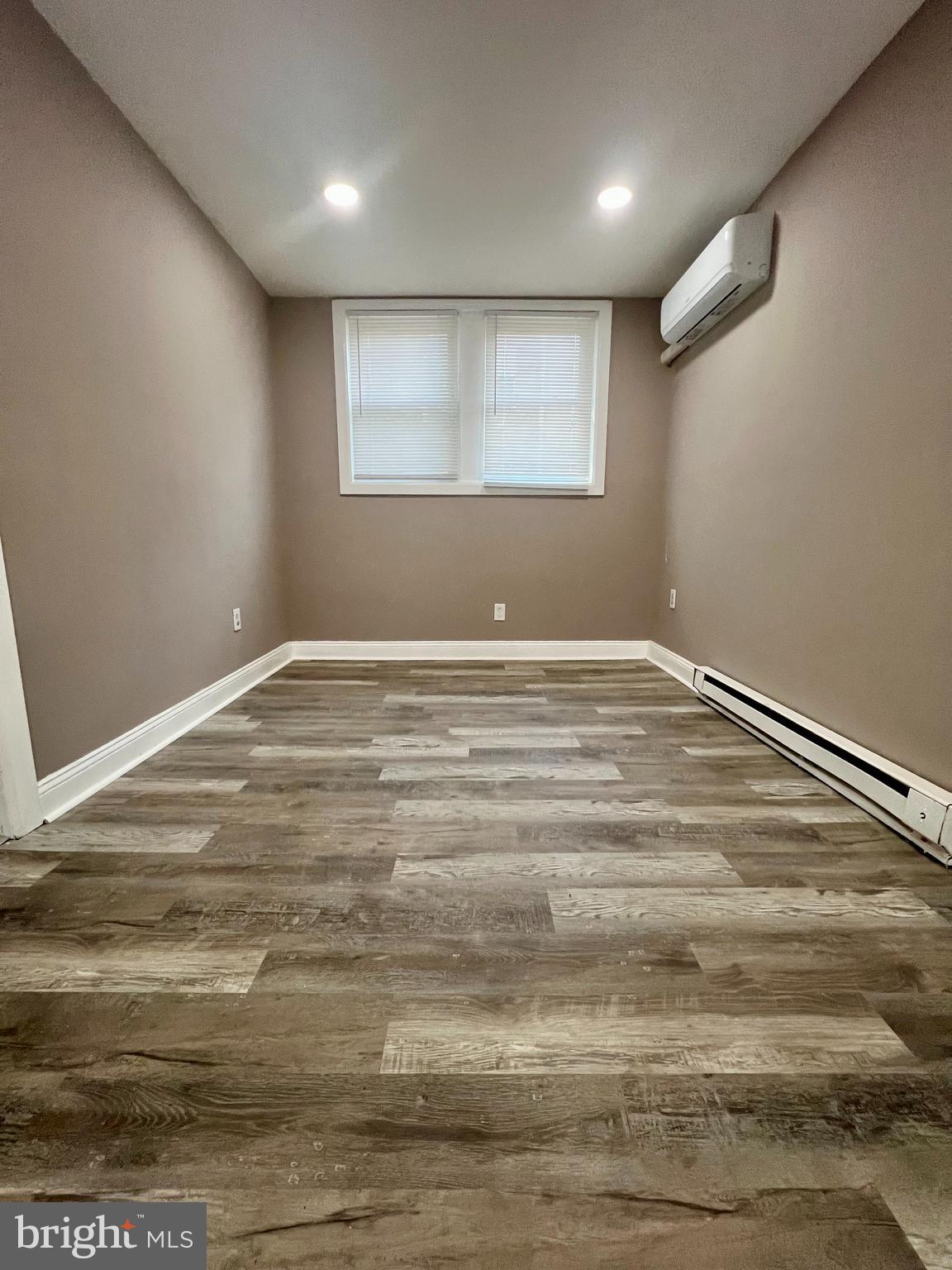 2610 Sylmar Street Philadelphia, PA 19142 - Photo 4 of 19 a view of an empty room with wooden floor and a window