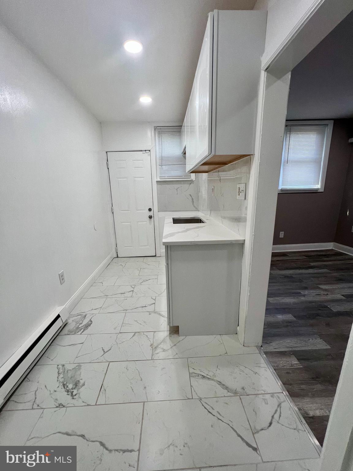 2610 Sylmar Street Philadelphia, PA 19142 - Photo 6 of 19 a kitchen with a sink cabinets and appliances