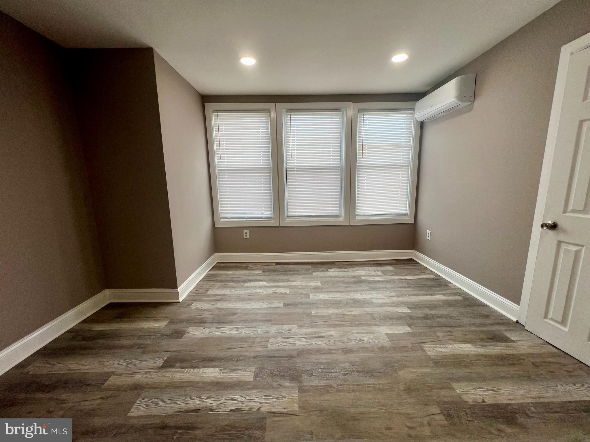 2610 Sylmar Street Philadelphia, PA 19142 - Photo 9 of 19 en empty room with wooden floor and window