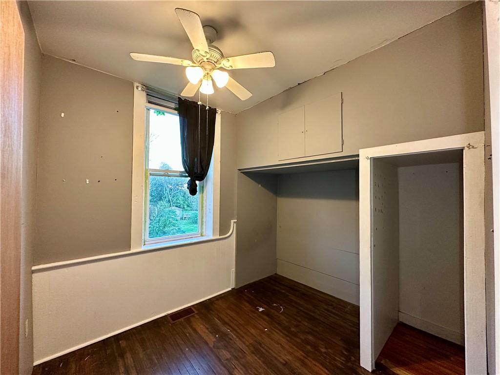 118 Firehall Road Portersville, PA 16051 - Photo 15 of 29 an empty room with wooden floor fan and windows