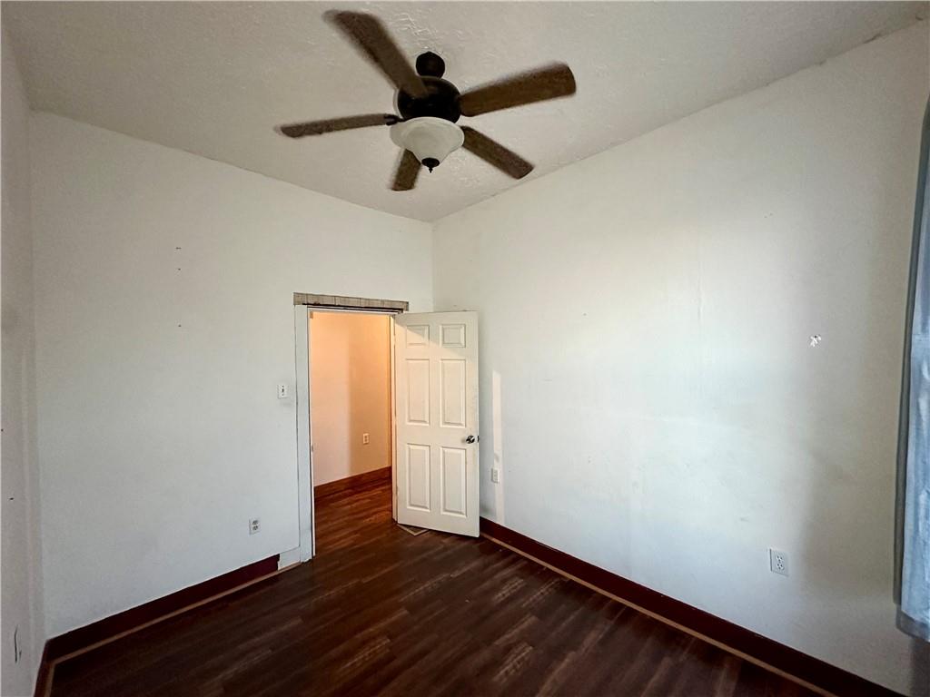 118 Firehall Road Portersville, PA 16051 - Photo 25 of 29 an empty room with wooden floor and a ceiling fan