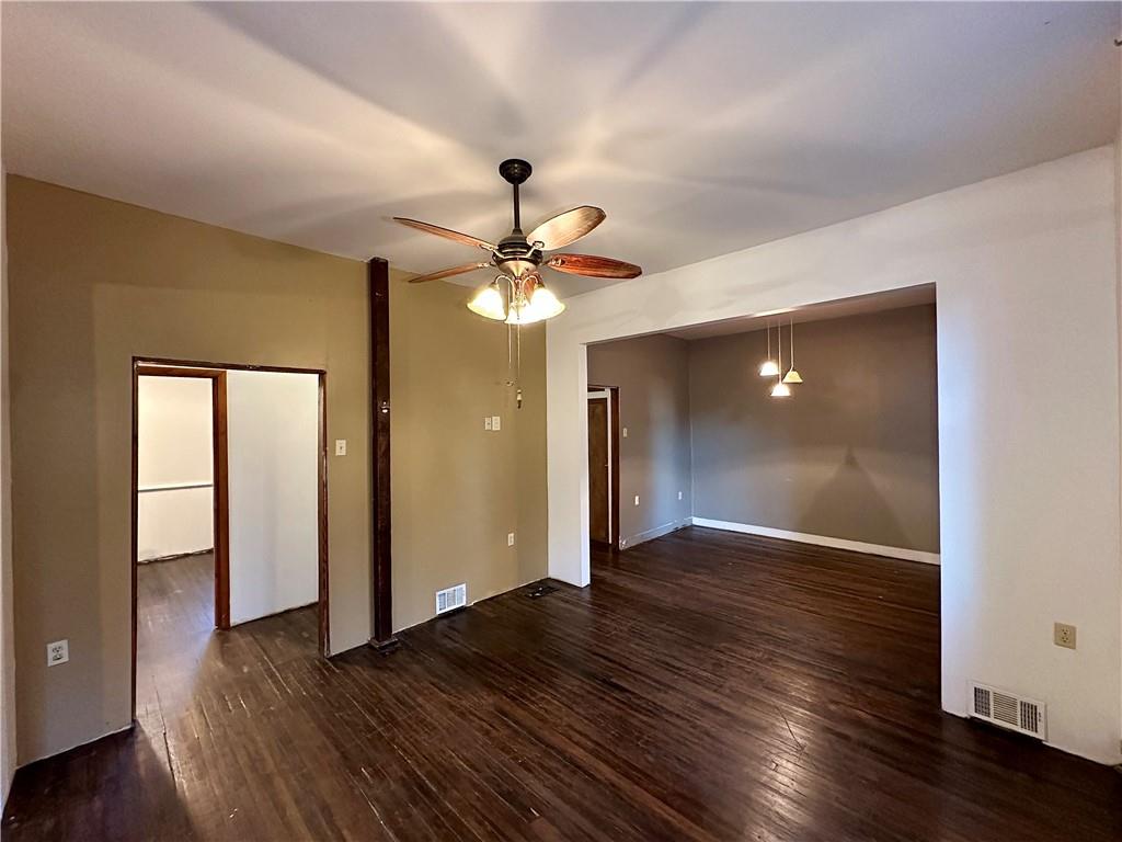 118 Firehall Road Portersville, PA 16051 - Photo 10 of 29 an empty room with wooden floor and door