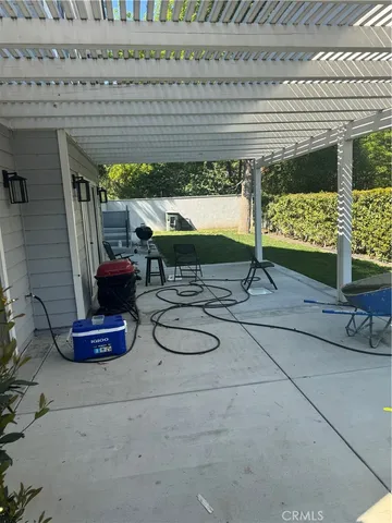a table with chairs and a vase of flowers