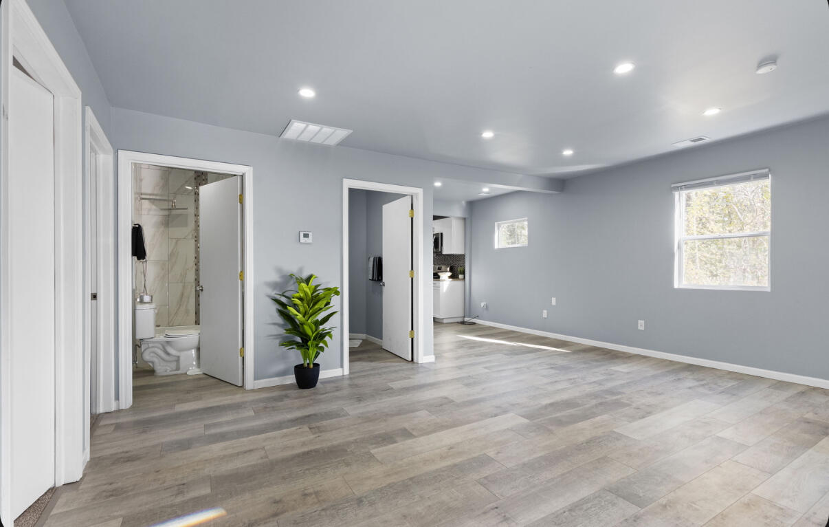 6344 West 25th Avenue Gary, IN 46406 - Photo 14 of 52 an empty room with wooden floor and windows