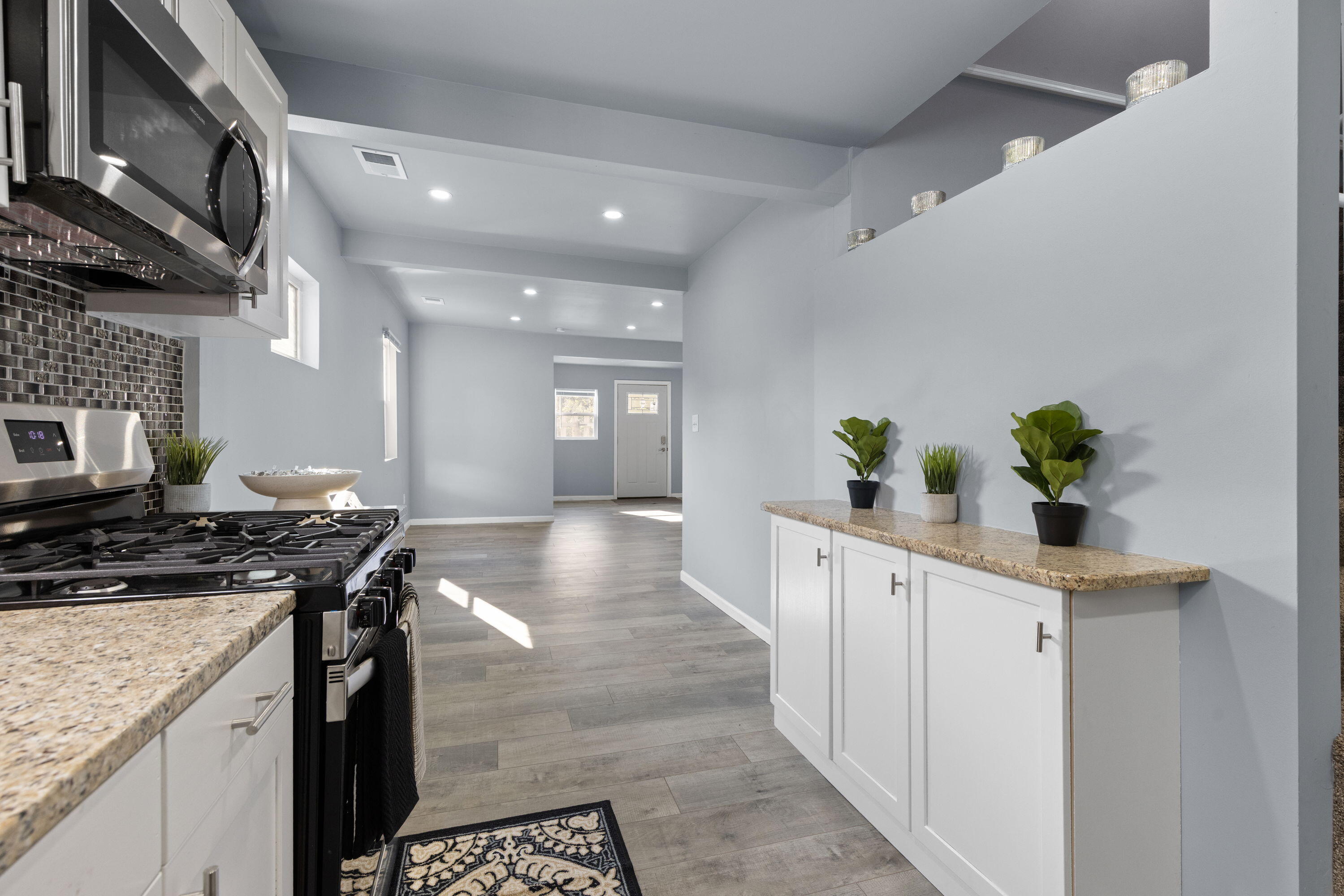 6344 West 25th Avenue Gary, IN 46406 - Photo 30 of 52 a kitchen with stainless steel appliances granite countertop a stove a sink a counter space and cabinets