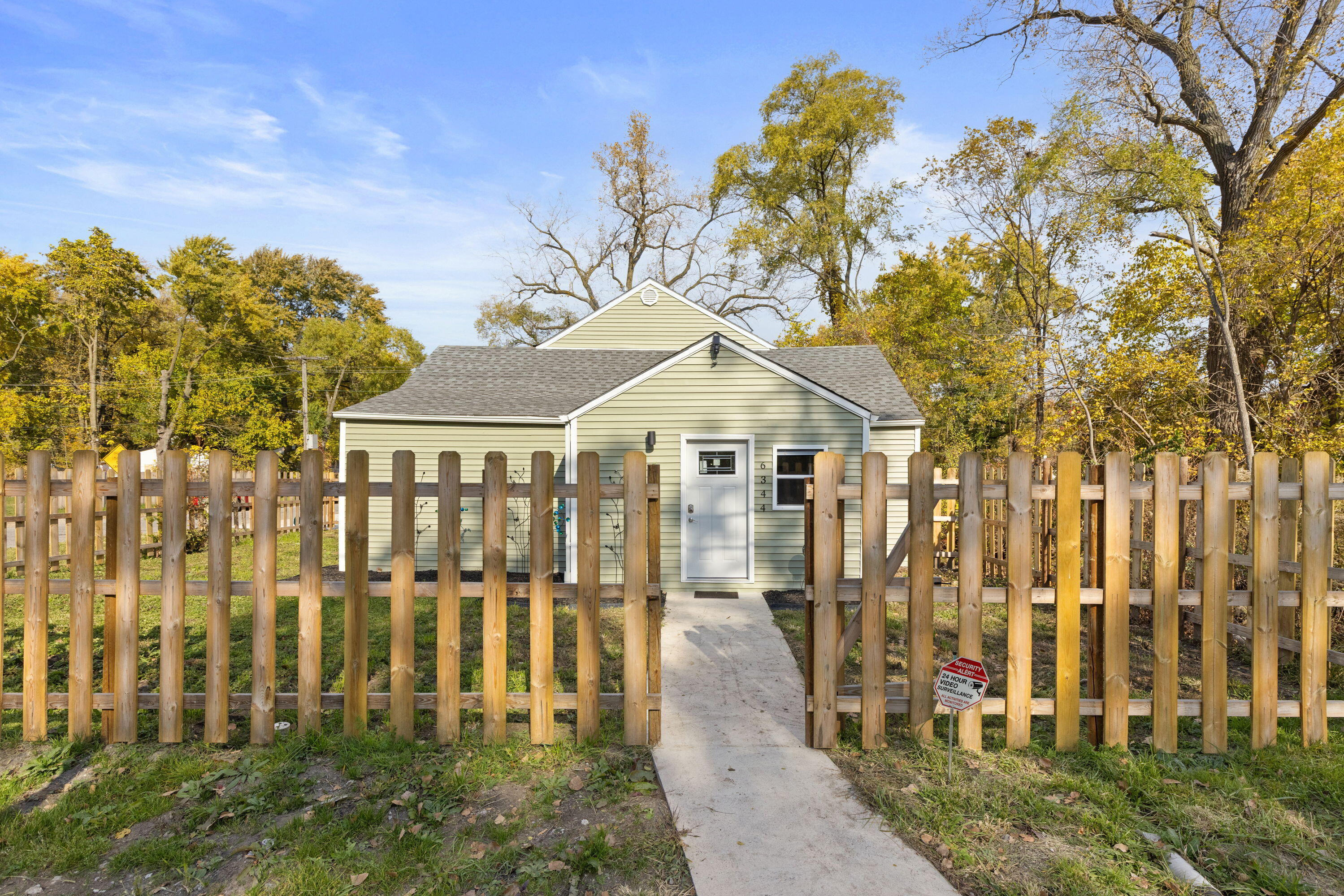 6344 West 25th Avenue Gary, IN 46406 - Photo 3 of 52 a view of a white house with a small yard and potted plants