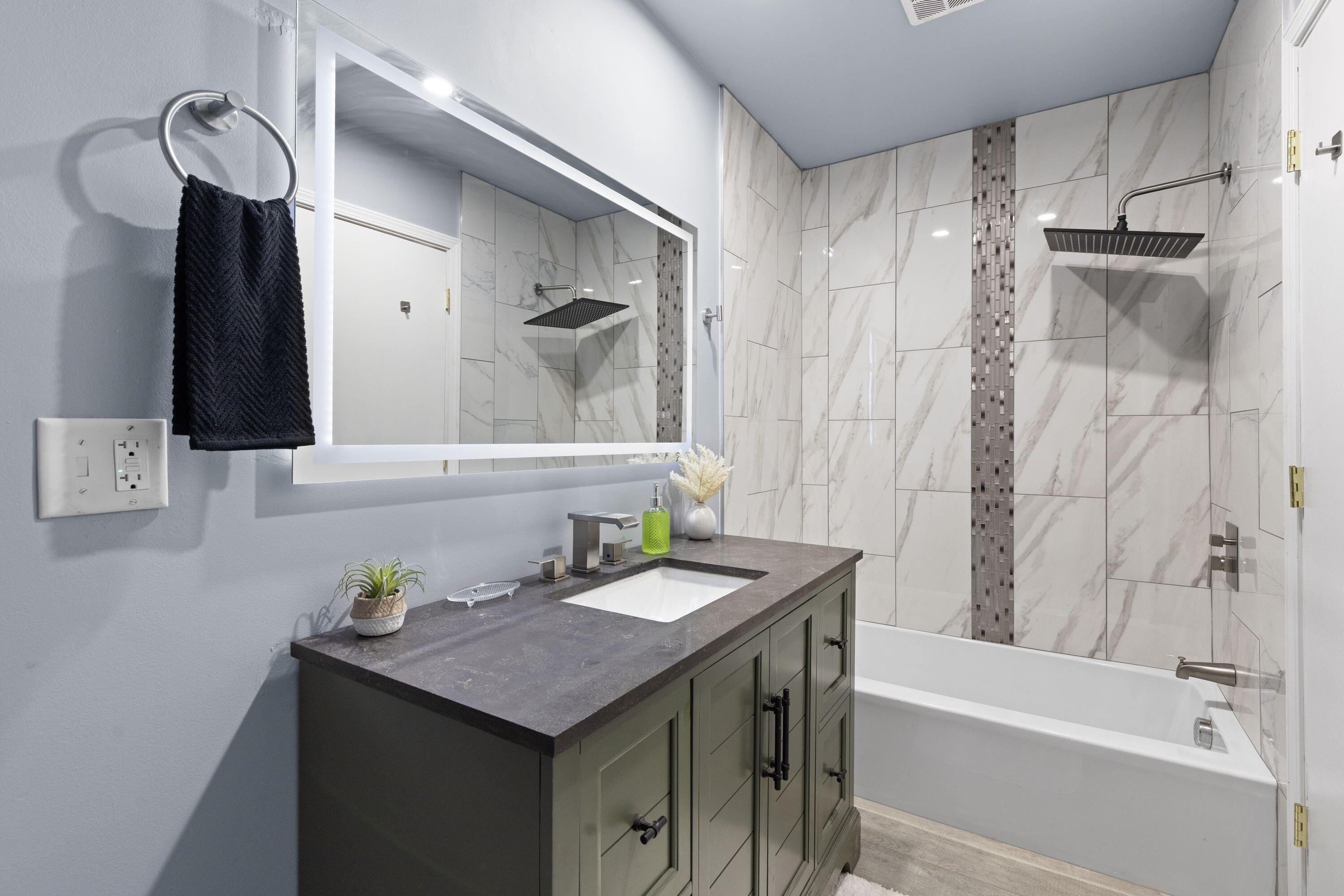 6344 West 25th Avenue Gary, IN 46406 - Photo 36 of 52 a bathroom with a granite countertop sink a mirror and a bathtub