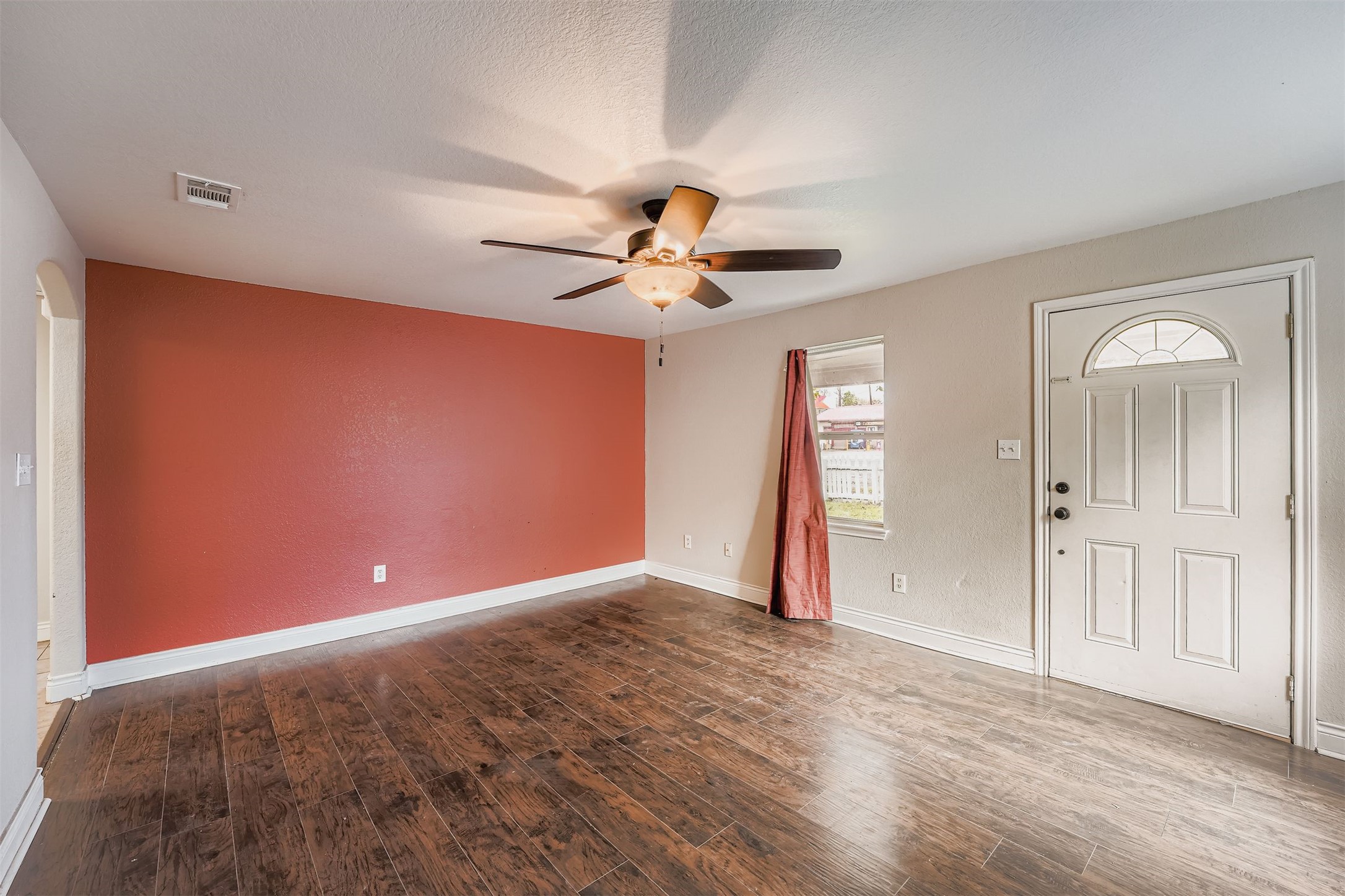 304 South Main Street Elgin, TX 78621 - Photo 9 of 25 Foyer with dark wood finished floors, ceiling fan, and a textured ceiling