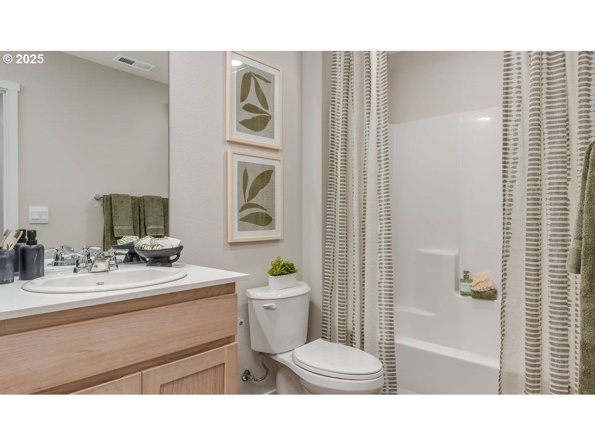 6121 Southeast 16th Street Gresham, OR 97080 - Photo 21 of 36 a bathroom with a sink a toilet and shower