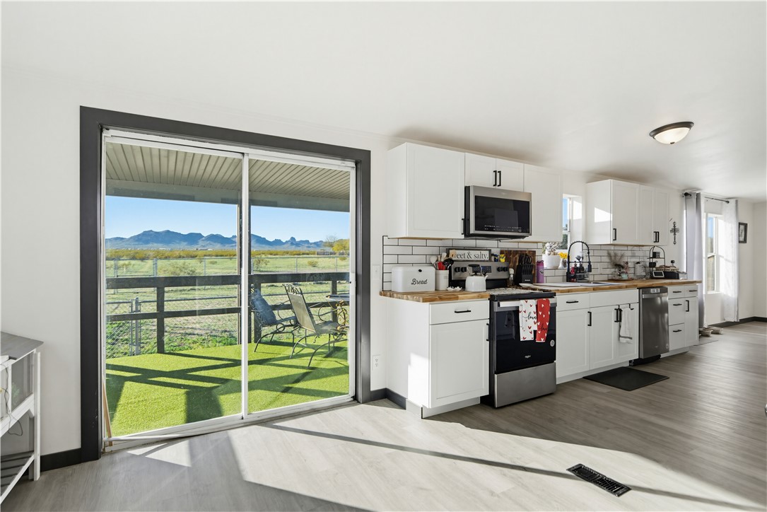 1071 South Estrella Road Golden Valley, AZ 86413 - Photo 13 of 50 a kitchen with stainless steel appliances a refrigerator and a stove top oven