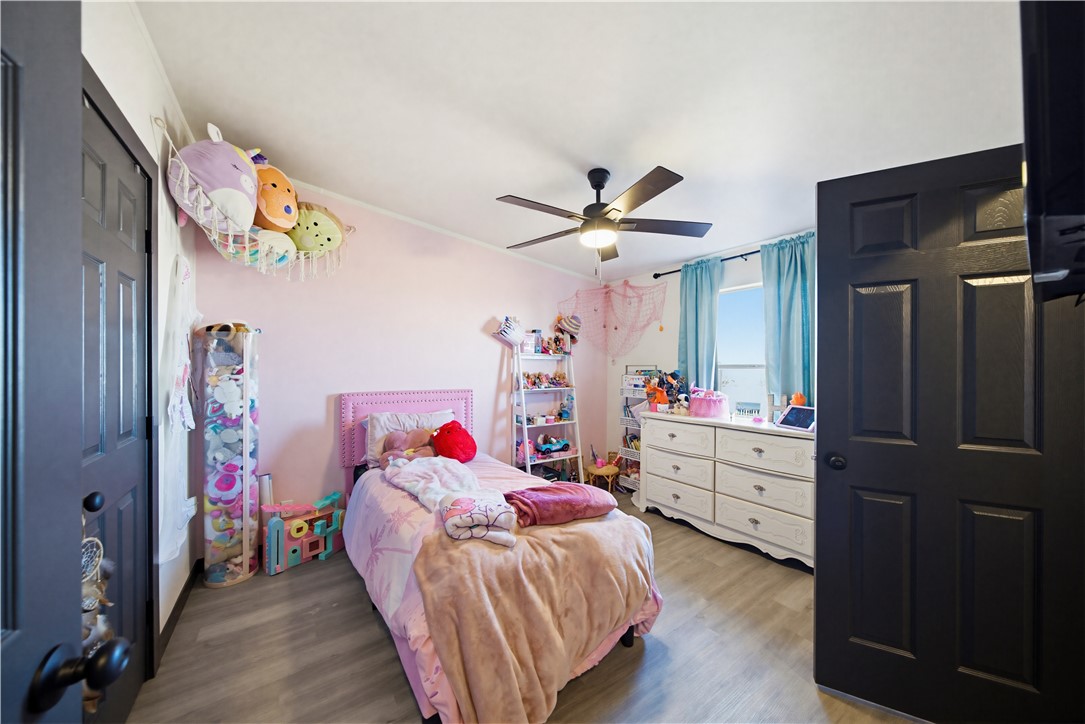 1071 South Estrella Road Golden Valley, AZ 86413 - Photo 16 of 50 a bed room with a bed and a chandelier