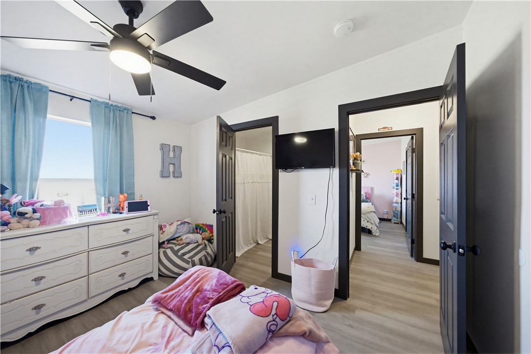 1071 South Estrella Road Golden Valley, AZ 86413 - Photo 17 of 50 a bedroom with a bed closet and flat tv screen