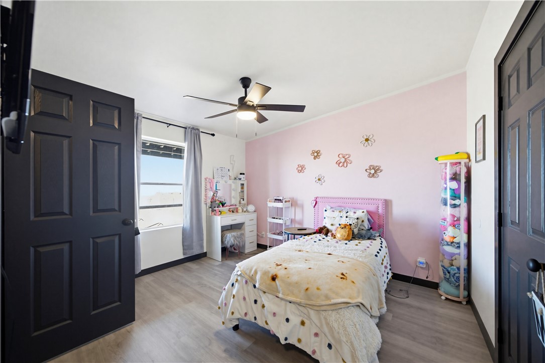 1071 South Estrella Road Golden Valley, AZ 86413 - Photo 20 of 50 a bedroom with a bed and wooden floor