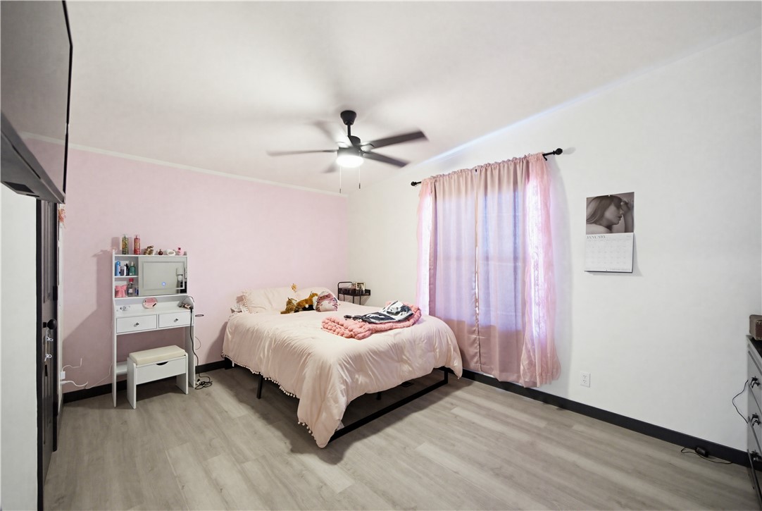 1071 South Estrella Road Golden Valley, AZ 86413 - Photo 22 of 50 a bedroom with a bed and a chandelier