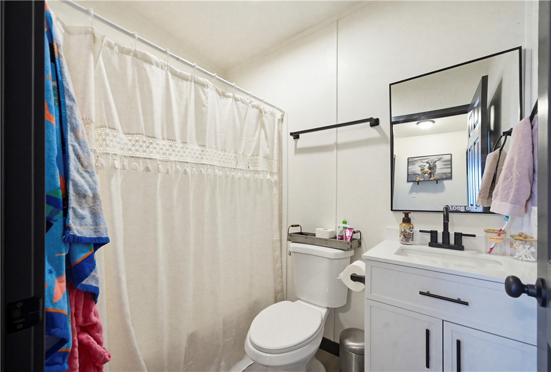 1071 South Estrella Road Golden Valley, AZ 86413 - Photo 24 of 50 a bathroom with a sink vanity mirror and toilet