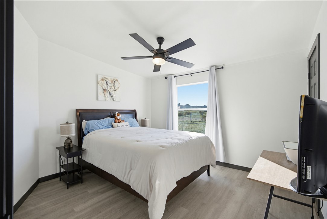 1071 South Estrella Road Golden Valley, AZ 86413 - Photo 25 of 50 a bedroom with a bed and a flat screen tv