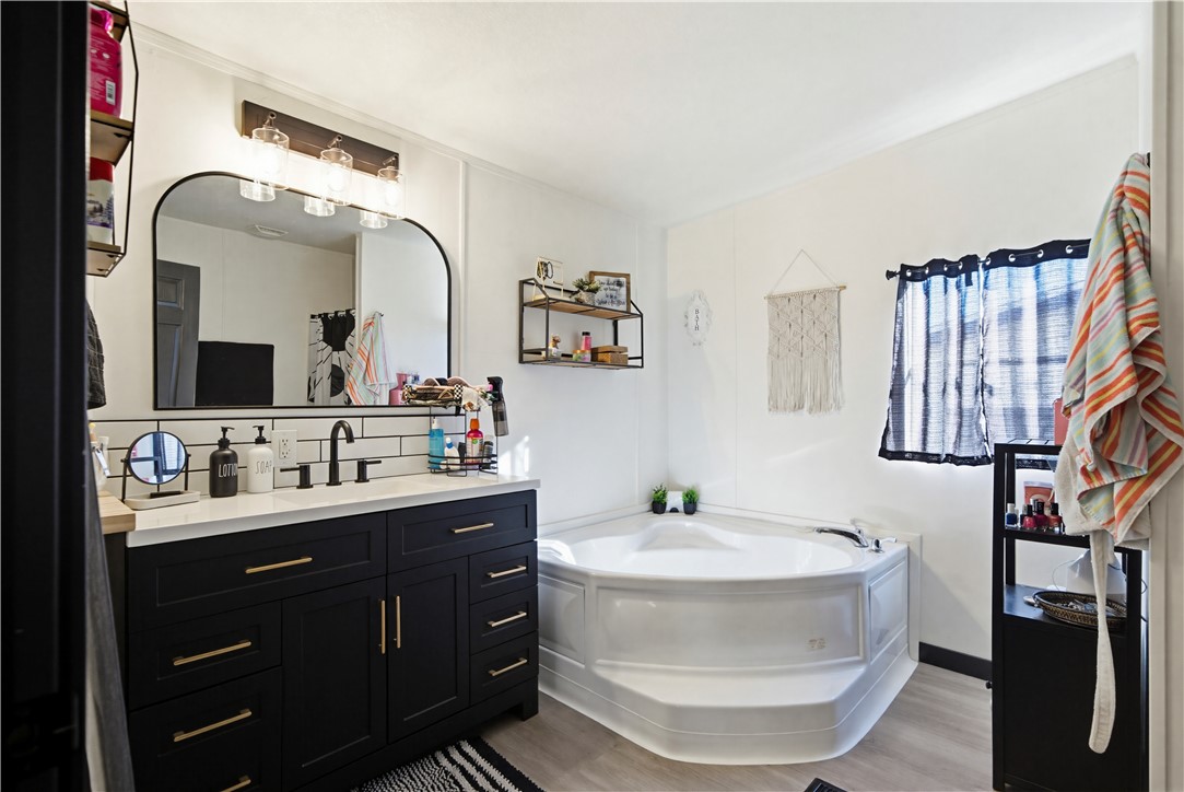 1071 South Estrella Road Golden Valley, AZ 86413 - Photo 29 of 50 a bathroom with a double vanity sink and a mirror
