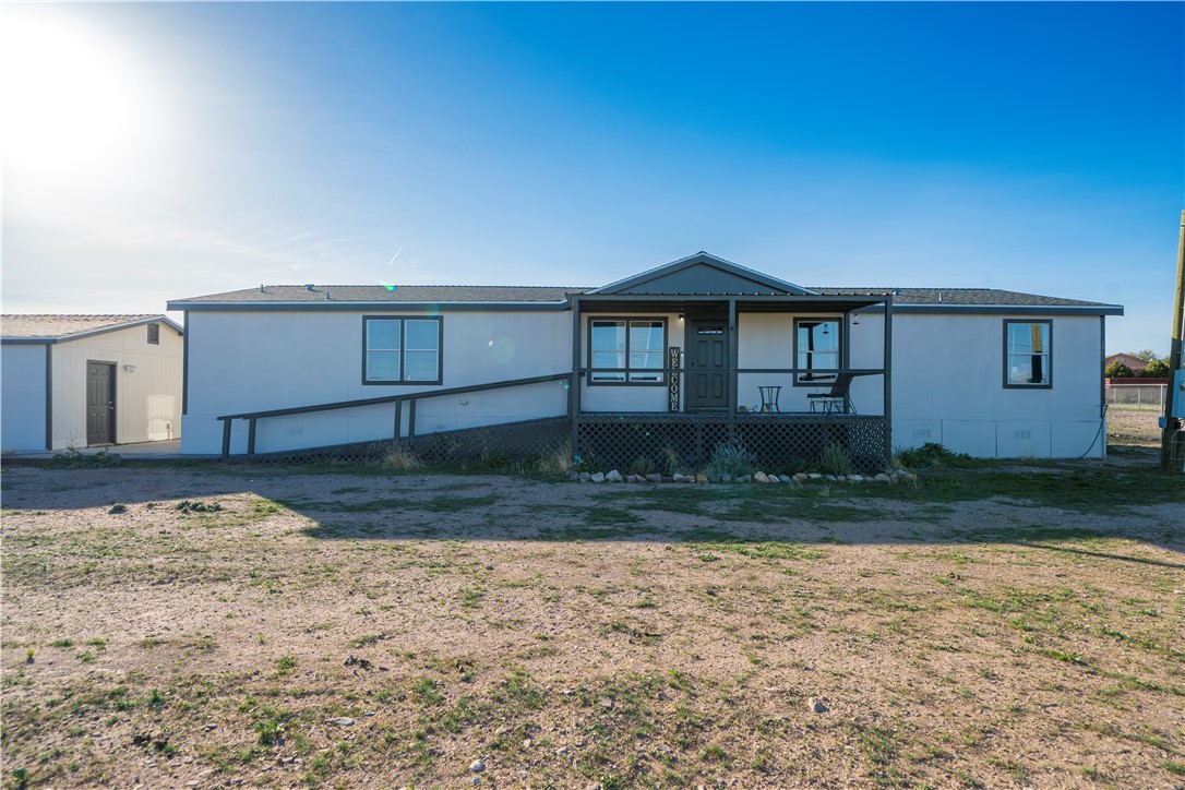 1071 South Estrella Road Golden Valley, AZ 86413 - Photo 35 of 50 a front view of a house with a yard