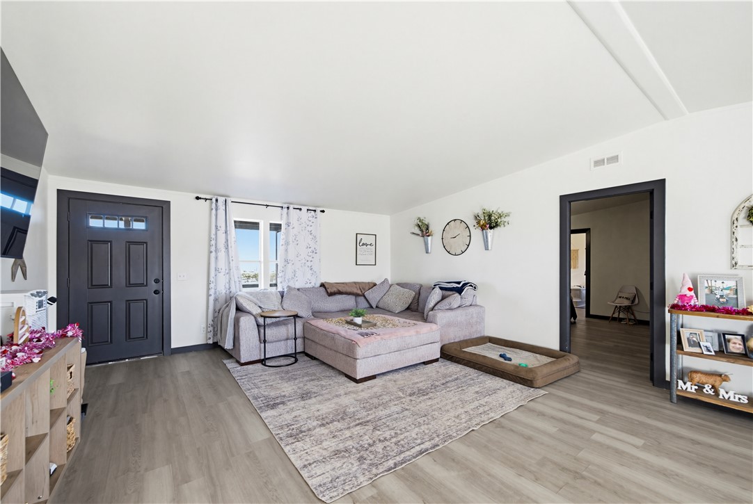 1071 South Estrella Road Golden Valley, AZ 86413 - Photo 6 of 50 a living room with furniture and a wooden floor