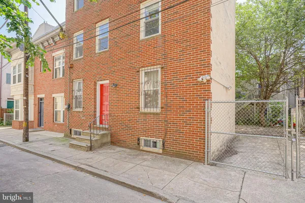 a view of a brick house with many windows