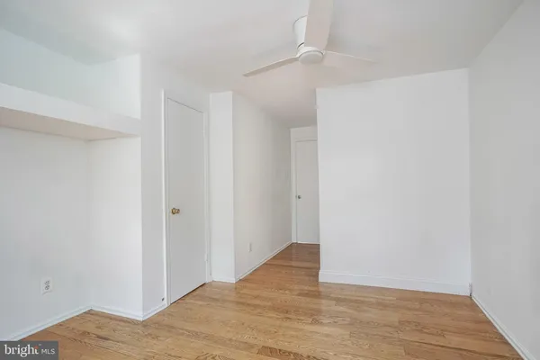 a view of a room with wooden floor