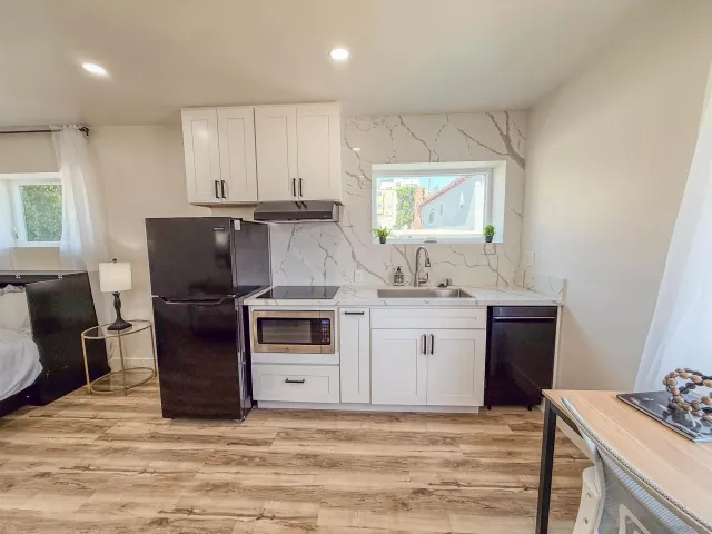 a kitchen with sink cabinets and wooden floor