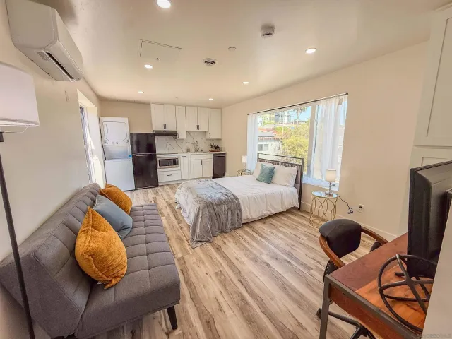 a bedroom with a large bed and a large mirror