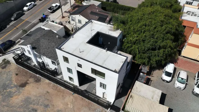an aerial view of a house with a yard