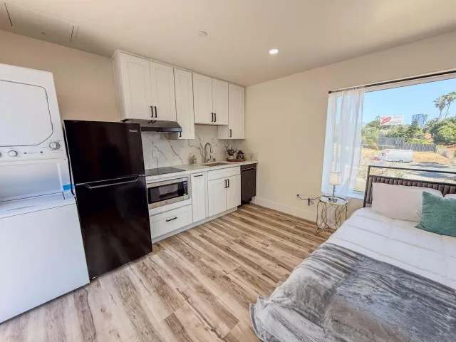 a kitchen with a sink a refrigerator and cabinets