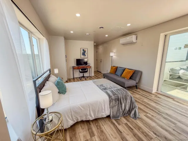 a living room with furniture and wooden floor