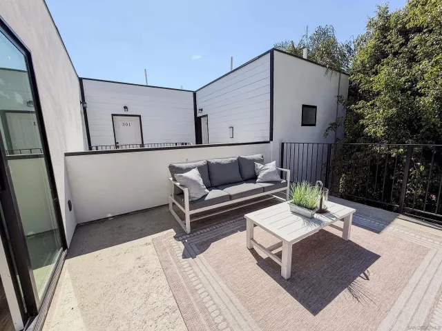 a view of a balcony dining table and chairs