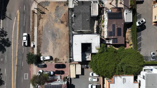 an aerial view of a residential houses with yard
