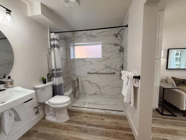 a bathroom with a sink toilet and mirror