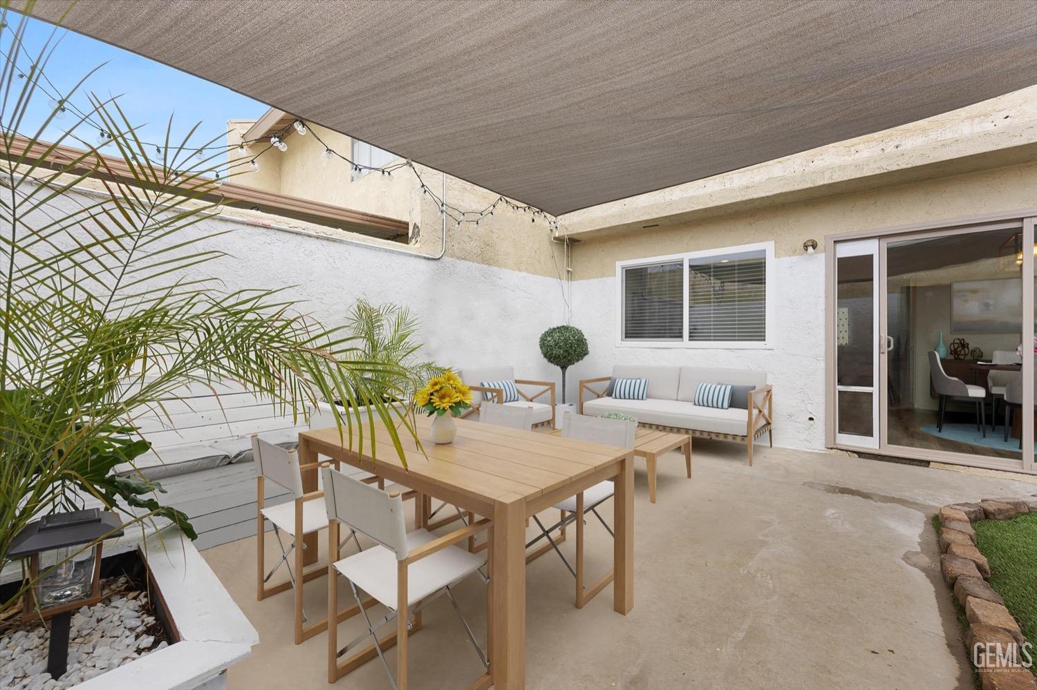 Undisclosed Address Bakersfield, CA 93308 - Photo 14 of 40 a view of a patio with table and chairs and potted plants