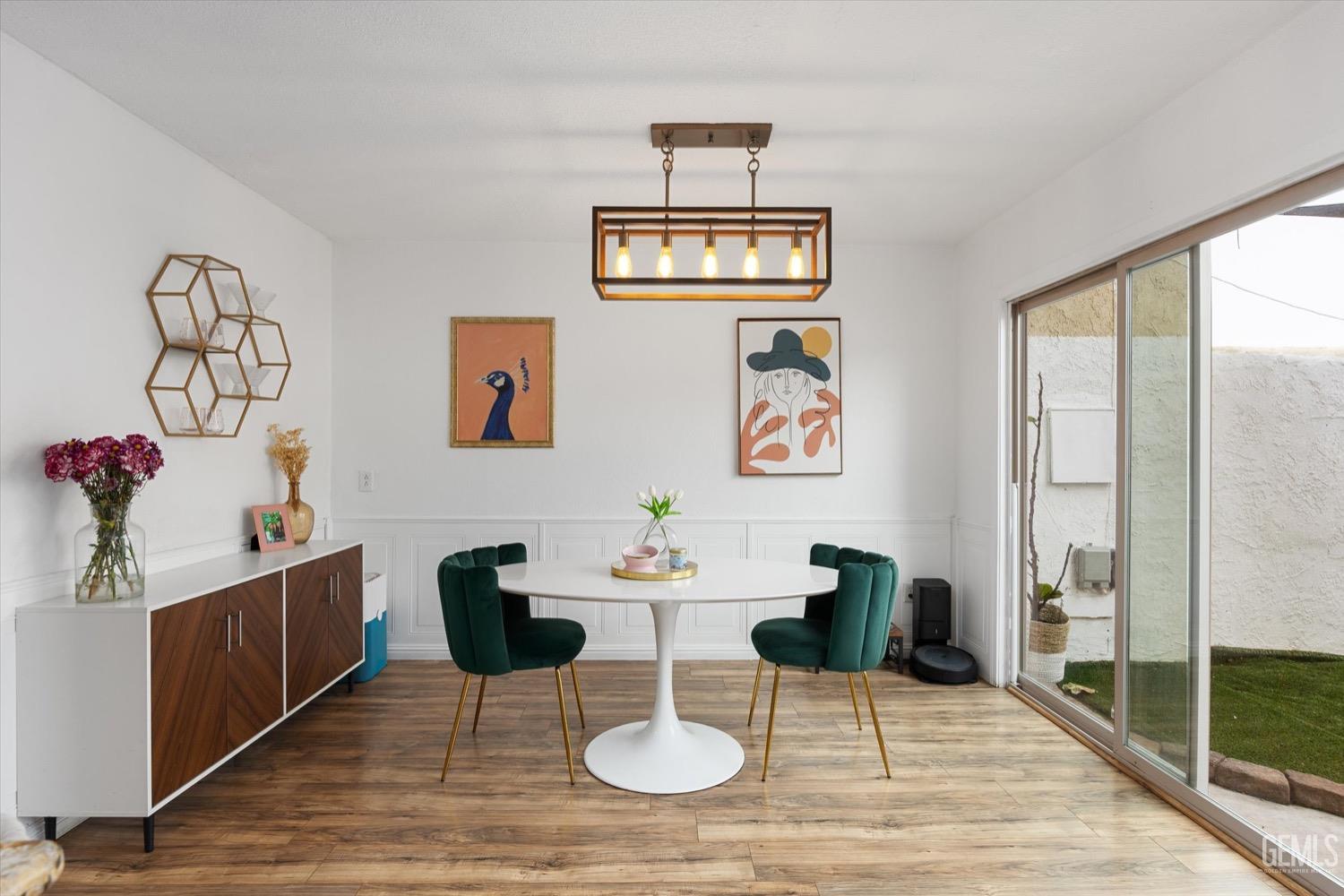 Undisclosed Address Bakersfield, CA 93308 - Photo 21 of 40 a dining room with wooden floor a chandelier a glass table and chairs